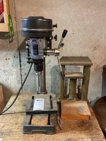 Full view of Durex Industrial drill press including base, adjustable worktable, and lever arm.
