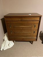Full front view showing four-drawer walnut dresser and overall shape