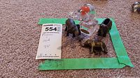 Photo showing the Murano glass elephant alongside three smaller metal elephants with maxsold tag and size note (3.5 inches).