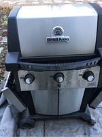 Front view of Broil King Signet propane BBQ with closed lid, showing the temperature gauge and brand logo.