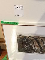 Partial close-up of the matted and framed print showing part of the rocky landscape image and corner of frame with measuring tape notes.