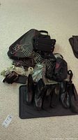Full overview of all items in the lot including boots, bags, belts, and metal coat hook