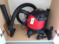 Front and side view of Craftsman wet dry vacuum with hose and attachments displayed.