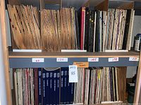 Shelf view of several hundred classical music LP records organized by numbered inventory labels 69, 120, 165, 179, 217