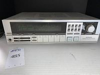 Front view of vintage Pioneer SX-50 stereo receiver showing digital display, tuning knob, buttons, and headphone jack.