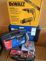Overview of five boxed tools: DeWalt screwdriver/cut-out tool, Kreg jig in case, Craftsman Laser Track level, Porter-Cable finish nailer and Weller soldering kit