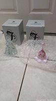 Two Fenton glass pieces with their original boxes, shown on bubble wrap.