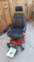 Front view of red Shoprider power wheelchair with black seat showing overall condition