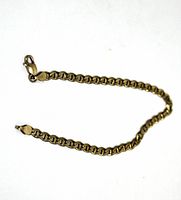 Full view of the gold bracelet laid out showing chain links and clasp.