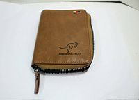 Front angled view of tan leather AIKS Kangaroo wallet showing zip closure and logo.