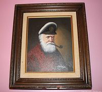 Full view of the framed artwork showing an old seafarer with white beard, captain's hat, and pipe.