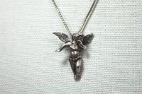 Close-up photo of the sterling silver cherub pendant showing detail of the cherub figure and wings.