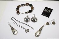 Photo of overall jewelry lot showing multiple pairs of earrings on cards and necklace with butterfly pendant.