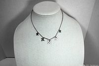 Front view of sterling silver flower necklace on display bust.