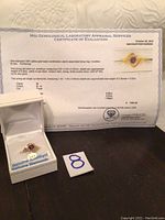 MGI certificate of evaluation and ring displayed in box