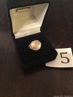 Frontal view of ring in open Jostens box