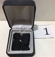 Pair of earrings displayed in presentation box on black foam insert