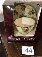 Royal Albert cup and saucer set in original box showing floral pattern and gold trim