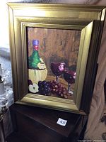 Front view of framed oil painting showing the complete scene of wine bottle, grapes, apples, and glasses.
