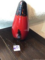 Royal Doulton Flambé Centenary Vase in red and black glaze with orange highlights, showing overall shape and color.