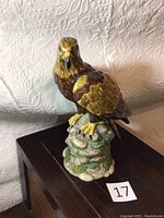 Front view of Royal Doulton golden eagle porcelain figurine showing detailed feather painting and rocky base.