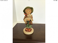 Front view of The Lost Sheep Hummel figurine showing a boy holding a lamb.
