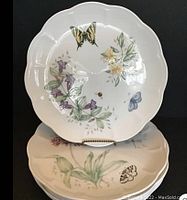 Six Lenox Butterfly Meadow dinner plates each adorned with unique butterfly and floral designs, showing scalloped edges and excellent condition with no utensil marks.