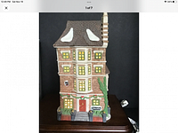 Front view of Dept. 56 Dickens Village 'Nephew Fred's Flat' showing detailed building facade, lighted windows, and snow accents on roof and chimney.