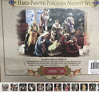 Printed box front featuring photo of nativity scene and branding text