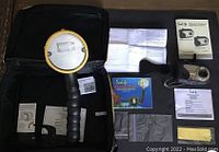 Contents of the lot including underwater flash light with ergonomic grip, assisting manuals and documents inside black carrying case.