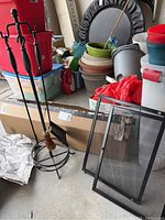 Photo showing the fireplace tool set with stand including poker, brush, and shovel