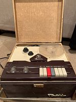 Full view of the Bell reel to reel tape recorder showing the control panel with buttons, knobs, and plastic reel.