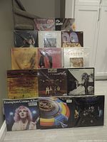 Full lot of 14 LPs arranged vertically showing album cover art