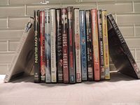 Photo showing 15 DVD cases arranged upright.