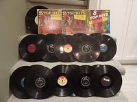 All records laid out showing front covers of 3 mini 33 1/3 LPs and 21 78 RPM records with visible record labels
