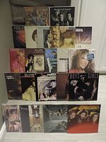 Overview photo of 21 vinyl LPs stacked in three rows showing album covers of various artists including Elvis, Rod Stewart, Neil Diamond, and more.