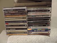 Photo of 30 stacked CD cases showing various artists and genres.