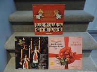 Three vintage 1960s Christmas LP records displayed on carpeted stairs, showing front covers