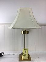 Lamp shown with the shade off-white octagonal and lamp unlit on a light background.