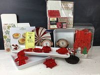 Overview of the holiday kitchen items including baking dishes, cookie cutters, tartlet pans, packaging, and kitchen towels.