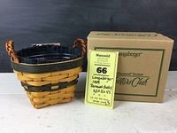 Longaberger 1999 Renewal Basket with original box and Maxsold auction tag displayed on table.