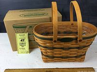 Photo showing entire basket with handles and original box in background along with measuring ruler.