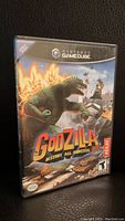 Front cover of the game case showing Godzilla and Mechagodzilla with title and branding.