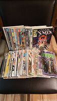 Overview of about 50 vintage comic books stacked and shelved in protective sleeves. Various titles and colorful covers visible including Classic X-Men and Star Wars Return of the Jedi.