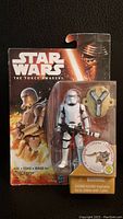 Front view of sealed Star Wars The Force Awakens First Order Flametrooper action figure in packaging, showing figure, blaster accessory, and branding.