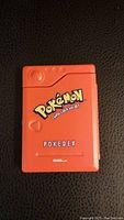 Closed view of the red Pokemon Pokedex with front logo and branding