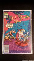 Photo of the front cover of the vintage Ren and Stimpy #1 comic book newsstand variant edition with colorful cartoon characters on a blue background.