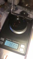 Photo of a digital scale displaying the weight of the almandine garnet parcel as 3.66 carats.