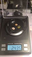 Three untreated Ethiopian opals on a jeweler's scale showing total weight 2.435 carats