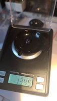 Natural tanzanite gemstone on digital scale showing weight of 1.345 carats.